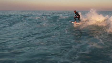 professional-surfer-riding-wave-for-long-without-falling,-Tracking-shot
