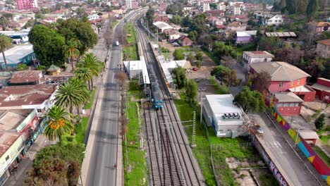 Aerial-drone-view-of-suburban-railroad-at-Quilpue-station,-Valparaiso-region,-Chile