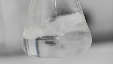 Closeup-Of-A-Liquid-Flask-In-A-Lab-During-A-Science-Experiment