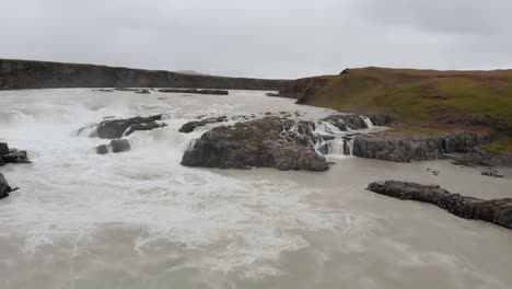 Aerial-of-waterfall-in-Iceland,-grey-day-during-summer-tourism