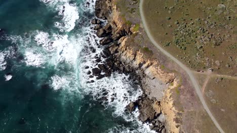 Waves-hitting-cliffside-from-top-down-view