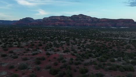 Hiking-Trail-On-Semi-arid-Landscape-In-Sedona,-Arizona-With-Red-Sandstone-Formation-In-Background