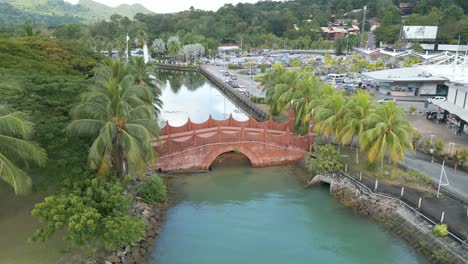 Small-arch-bridge-on-a-river-in-Langkawi-with-mountain-and-jungle-at-background