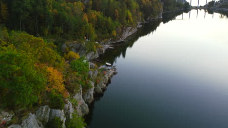 aerial-top-down-of-rocky-cliffside-overlooking-river-on-Orust-Island-in-Sweden-at-dusk