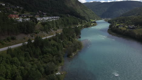 Aerial-drone-forward-moving-shot-over-winding-Otta-river-in-Lom,-Norway-at-daytime
