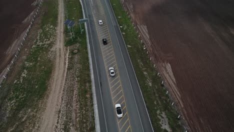 AERIAL---Cars-on-highway,-cloudy-day,-Reynosa,-Tamaulipas,-Mexico,-forward-top-down