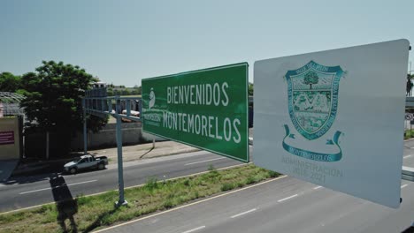 AERIAL---Road-sign-and-highway-traffic,-Montemorelos,-Nuevo-León,-Mexico,-static