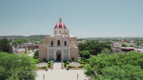 AERIAL---Church-and-park,-Montemorelos,-Nuevo-León,-Mexico,-forward-rising-shot
