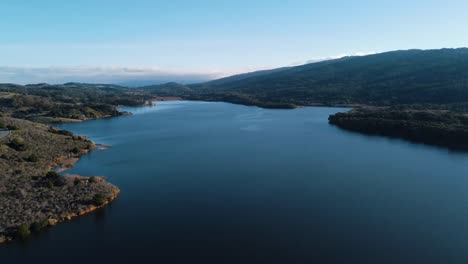 Drone-aerial-flyover-California,-Bay-Area,-trees-and-reservoir-water,-San-Mateo