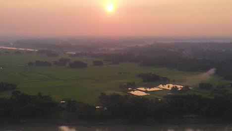Early-morning-landscape-of-river-with-boats-in-Sylhet,-Bangladesh,-aerial