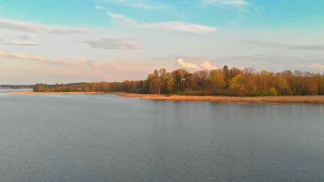 Approaching-Jugla-lake-shores-Riga-at-golden-hour-aerial