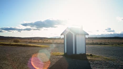 Irishman-Creek-Station-hut-against-the-bright,-warm-evening-sun-with-lens-flares
