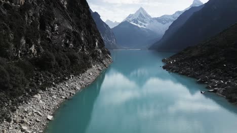 Lake-Paron,-Pyramid-Mountain,-Aerial-Drone-Above-Water-Andean-Cordillera-in-Peru-Huascaran-National-Park,-Peruvian-Hiking-Destination