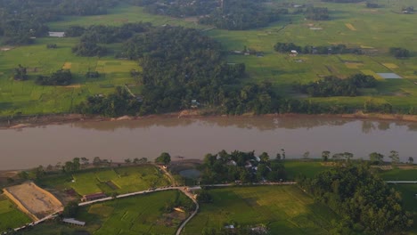 Aerial-view-of-Surma-River-in-Bangladesh,-Sylhet,-with-countryside-fields