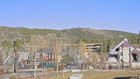 Tourists-and-cyclists-moving-through-the-downtown-area-of-Breckenridge,-Colorado-in-the-fall