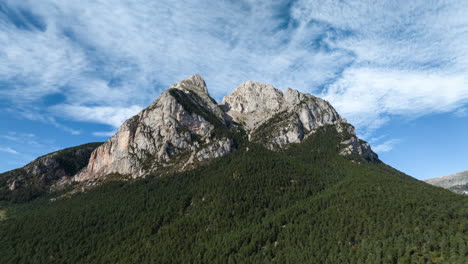 Panoramic-Pedraforca-massif-with-fast-cloudscape-movement-aerial-view-rising-hyper-lapse