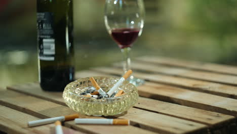 Cigarettes-slowly-burning-in-ashtray