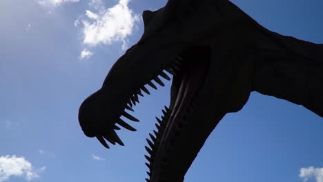 Mysteriöse-Gruselige-Horrorsilhouette-Eines-Gigantischen-Alten-Historischen-Tierdinosauriers-Mit-Offenem-Mund-Massive-Zähne-Groß-Hoch-Teilweise-Bewölkt-Zeitlupe