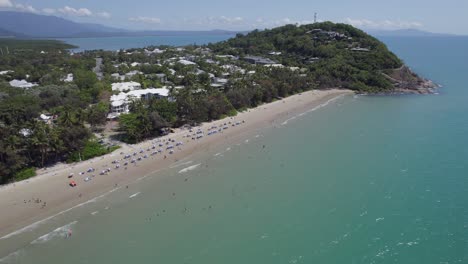 Tourists-Enjoying-Summer-Holidays-At-Four-Mile-Beach-In-Port-Douglas,-Queensland,-Australia---aerial-shot