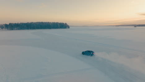 Drifting-car-speeding-on-corner-on-Norbotten-woodland-ice-lake-aerial-tracking-view-at-sunrise