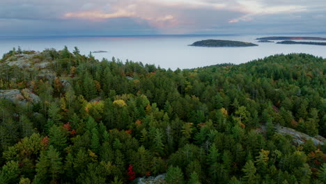 Drone-shot-flying-over-mountain-with-lake-superior-in-the-background