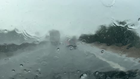 Driving-during-a-storm-of-rain-and-hail,-driver-point-of-view