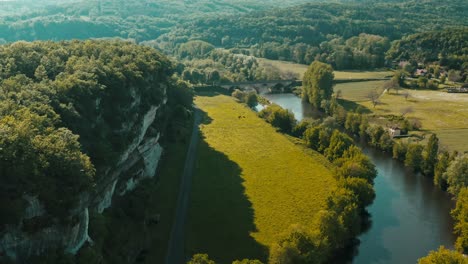 A-wild-valley-with-cliff-and-river,-aerial-shot-in-spring,-Dordogne-in-France