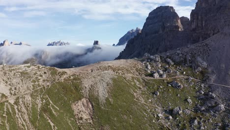 Aerial-moving-over-Tre-Cime-Di-Lavaredo-mountains-with-low-clouds