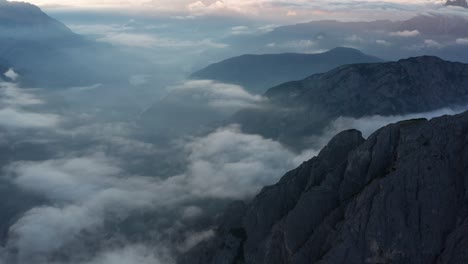 Aerial-over-Tre-Cime-Di-Lavaredo-mountains-with-low-clouds-and-sunrise