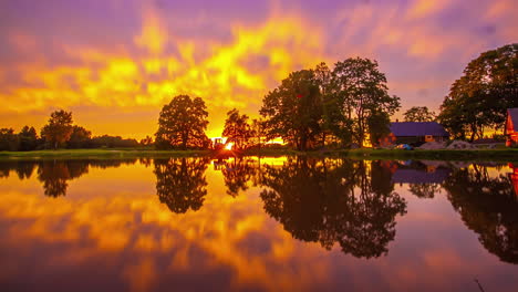 Majestic-Sunset-Timelapse-Of-Over-Lake-With-Pink,-Purple-Cloudscape-Skies