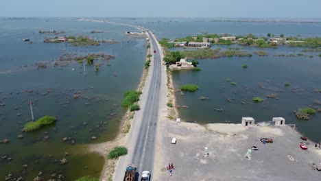 Aerial-View-Of-Road-Surrounded-By-Flooded-Landscape-On-Either-Side-In-Sindh,-Pakistan