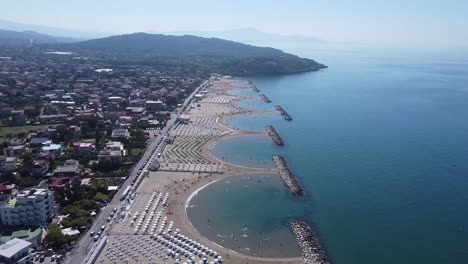 Luxury-Formia-beach-on-Italy-coastline,-aerial-fly-away-view