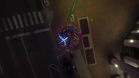 Top-down-aerial-of-lit-Christmas-tree-at-night
