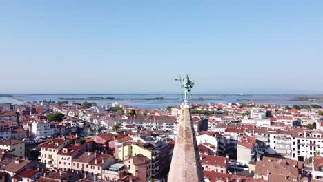 Aerial-orbit-view-of-Angel-Church-and-rooftops-of-Grado-city