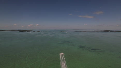 Speedboat-Racing-Off-Into-Distance-Over-Green-Waters-Off-Florida-Keys