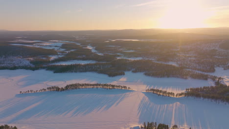 Golden-sunrise-snowy-drifting-racetrack-Polar-circle-with-long-shadows-across-the-landscape