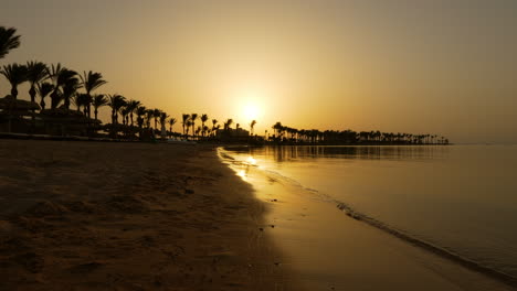 Warm-Sunset-With-Palm-Tree-Silhouettes-At-Sentido-Palm-Royale-Resort-In-Hurghada,-Egypt