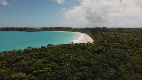 The-Isle-of-Pines-tropical-paradise-with-a-view-of-the-beach-and-Bay-of-Rouleaux---aerial-flyover