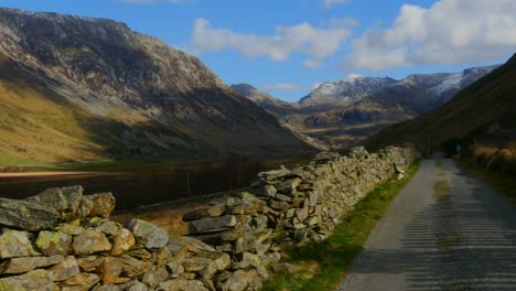 A-Camera-Track-across-a-wall-and-road-in-the-beautiful-Nant-Ffrancon-Pass-in-Wales-in-the-UK