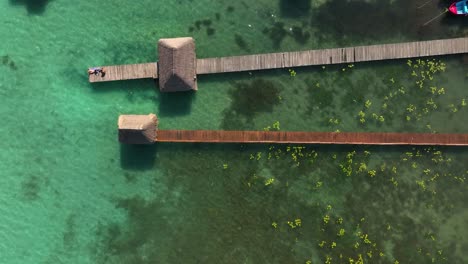 Aerial-view-above-piers-in-the-Bacalar-town,-Quintana-roo,-Mexico---top-down,-drone-shot