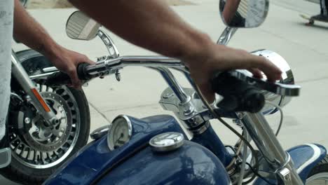 Close-up-of-man-stepping-off-his-motorcycle,-Latino-person-getting-of-from-a-chopper-motorcycle