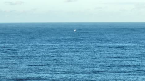 Aerial-telephoto-shot-of-single-lone-Sailing-Yacht-in-ocean,-at-full-sail