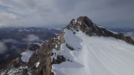 Drone-flight-over-snowy-mountaintop-of-Kitzsteinhorn-Mountain-in-Austria-near-Salzburg