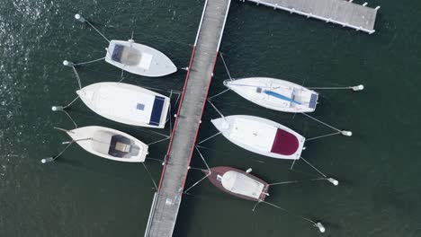 Drone-tracking-shot-of-some-boats-in-a-small-harbor-on-the-Australian-coast,-no-people,-daylight,-sunny-day