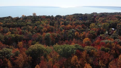 A-high-angle-aerial-view-flying-over-Michigans-autumn-foliage