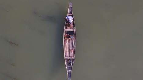 Aerial-view-of-Asian-fisherman-fishing-on-wooden-traditional-boat