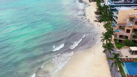 turquoise-blue-ocean-shoreline-of-Playa-Del-Carmen-Beach-in-Mexico,-aerial