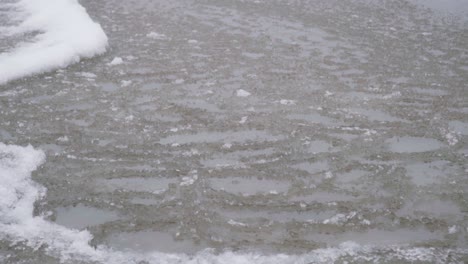 Slow-motion-panning-shot-of-ice-sheets-moving-in-the-waves