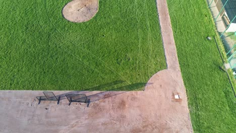 Panning-and-ascending-view-over-beautiful-green-baseball-field-in-Germany