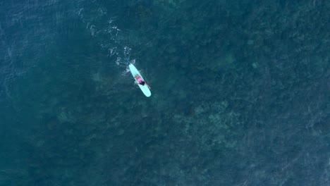 Aerial-Shot---Female-Surfer-Misses-A-Wave-in-the-turquoise-waters-off-the-coast-of-Mexico